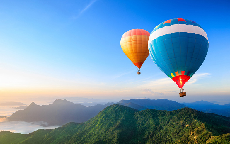 stock-photo-colorful-hot-air-balloons-flying-over-the-mountain-120085894
